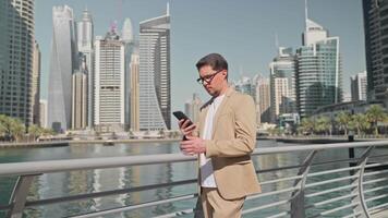Tourist stylish man finding destination using navigation map in phone in city. video