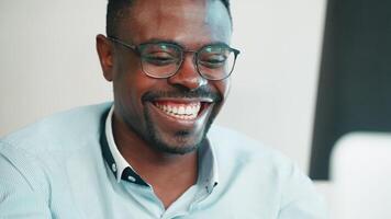 smiling black man working with computer video