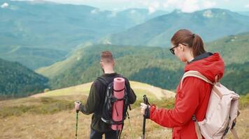 real hike in mountains in springtime, group of backpackers walking on top of hills and mountains video
