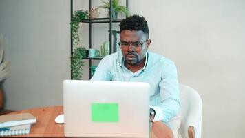 Serious man programmer coding on laptop. video