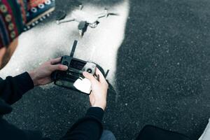 Drone remote control. Remote control in hand man. Man holds remote controller with his hands and controls the drone. photo