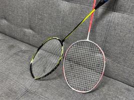 Competitive sports and high performance in tournament match conceptual idea with badminton rackets and shuttlecock with copy space photo