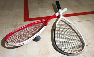 Sports, above and racket on squash court for competition, challenge and training center. Exercise, interior and empty room with top view of wooden floor of gymnasium for games, fitness club and gear photo