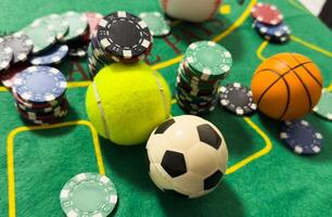 Conceptual background of online sports betting with objects representing different sports, money and chips to bet. Front view. photo