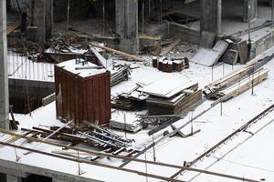 concreting work. construction site worker during concrete pouring into formwork at building area with skip photo