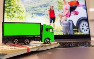 Logistics, and delivery service - Truck on a laptop keyboard. Shopping service on The online web and offers home delivery. photo