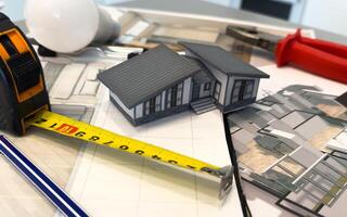Architectural engineering design plan drawing on the table. Architect's work on table in studio. Construction design and plan photo