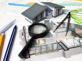 Architectural engineering design plan drawing on the table. Architect's work on table in studio. Construction design and plan photo