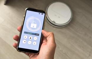 smart house, home automation, device with app icons. Man uses his smartphone with smarthome security app to unlock the door of his house. photo