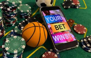 Online poker concept. Smartphone and poker chips on a green background. Poker online banner. Copy space. Vignette. Place for text. Gambling. Background photo