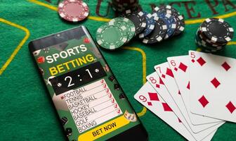 Smartphone, money, playing cards and chips. Online casino photo