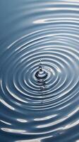A close-up of smooth water ripples radiating light in circular patterns. photo