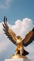 A detailed view of a golden eagle statue, wings outstretched, framed by soft-focus clouds, providing space for Presidents Day messaging. photo