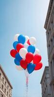 A sky full of red, white, and blue balloons floating upward, with a clear space for bold Presidents Day messaging. photo