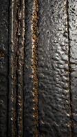 A macro photograph of rugged metal with visible marks and stains. photo