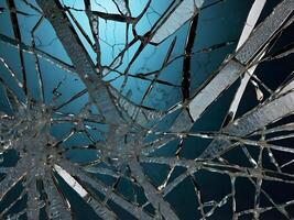A macro shot of shattered glass showing intricate, branching lines. photo