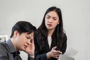 Concerned female professional addressing project issues with a distressed male colleague in a collaborative environment. photo