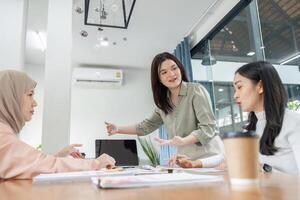 Diverse financial team discussing strategies in a modern office setting, showcasing collaboration and professionalism. photo