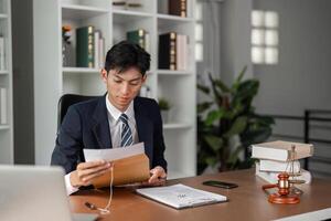 Young businessman reviewing important documents and preparing for tasks in a modern office setting. photo