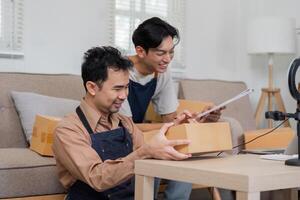 Two online sellers preparing packages for shipment, showcasing teamwork and entrepreneurship. photo