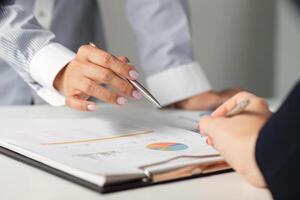Business professionals discussing financial strategies and analyzing reports in a collaborative office environment. photo