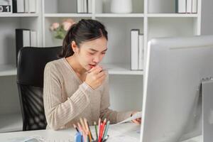Focused young woman working at a desk, analyzing documents and contemplating strategies in a modern office. photo