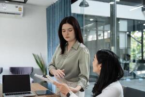 Financial professionals analyzing reports and discussing budgets in a collaborative office environment. photo