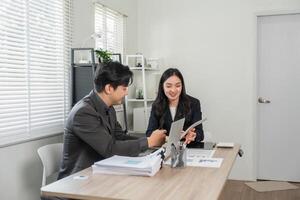 Diverse business professionals collaborating on financial reports and analysis in a modern office. photo