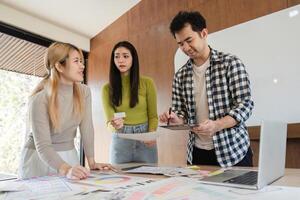 Diverse team collaborating on creative design project at modern office table. photo