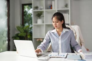 Finance expert engaged in data analysis and document management at a stylish office desk. photo