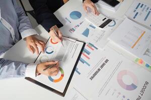 Accountants discussing budget strategies and financial reports in a collaborative workspace. photo