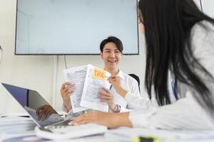 Team members presenting tax documents and strategies in a modern office setting. photo