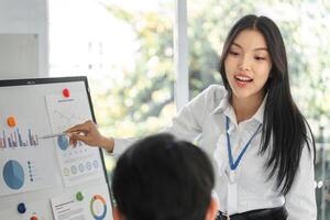 Professional explaining financial metrics and trends to a colleague photo