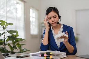 Concerned accountant handling financial difficulties while on a call, emphasizing the pressures of tax management. photo