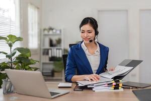 Smiling accountant reviewing financial documents and engaging with clients in a bright workspace. photo