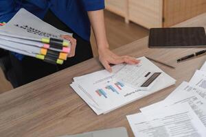 Accountant using calculator for financial analysis in office photo