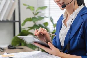Accountant on a call, using a tablet to assist with tax document management. photo