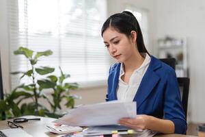 Accountant sorting through financial paperwork, ensuring accuracy and compliance in a modern office. photo