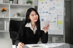 Accountant smiling while reviewing financial statements and calculations. photo