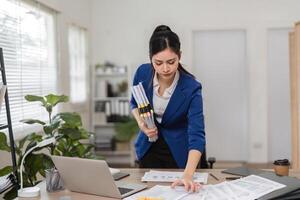 Accountant managing multiple tax files and reports in a well-organized office environment. photo