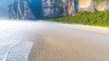 Majestic coastal cliffs and misty beach with rugged terrain and calm waves photo