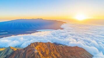 Aerial view of scenic mountain range with sun rising above clouds photo