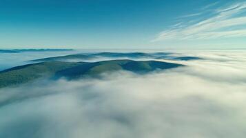 Aerial view of mountain landscape covered by mist and clouds in a serene horizon photo