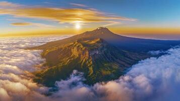 Aerial view of mountain peak surrounded by clouds at sunrise capturing serenity photo