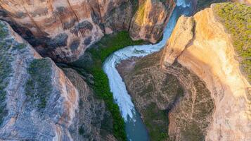 Aerial view of dramatic canyon with river cutting through rugged cliffs photo