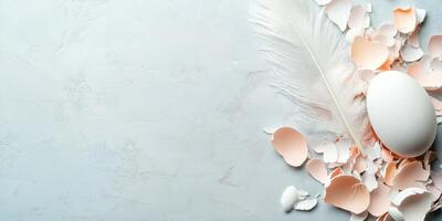 Fragile white egg with delicate shells and feather on textured surface photo