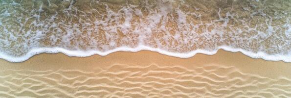 Aerial view of waves gently crashing on sandy beach shoreline pattern photo