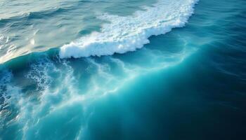 An aerial view of a wave breaking on the ocean photo