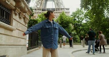 A woman in a denim jacket standing in front of the eiffel tower video