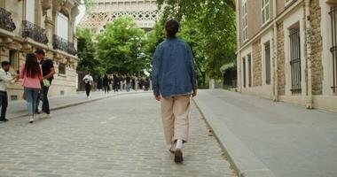 A person walking down a cobblestone street in front of a building video